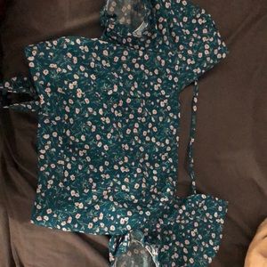 Green blouse that’s cropped with floral designs